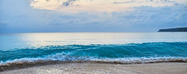 Wall Mural - Image with a vintage tonal filter effect with noise and grain. White sand beach and turquoise sea background. Coastline on sunny day background of sea and sky.