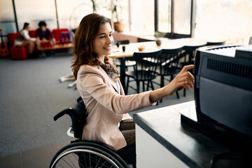 Wall Mural - Happy businesswoman with disability using coffee machine in office.