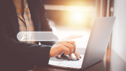 Wall Mural -  The concept of using technology to search engine optimizationfor information business woman using laptop to find online shopping information and other information for use in marketing