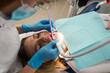 © Tania - Dentist-hygienist conducts a teeth cleaning procedure for a girl in a dental clinic. Removal of tartar.