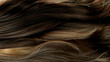 Closeup on luxurious curly brown hair with highlights.