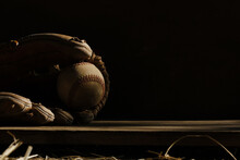 Dramatic And Dark Sports Concept With Baseball Equipment On Black Background.