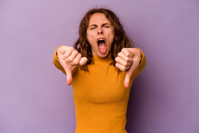 Young Caucasian Woman Isolated On Purple Background Showing Thumb Down And Expressing Dislike.