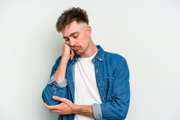 Wall Mural - Young caucasian man isolated on white background who feels sad and pensive, looking at copy space.