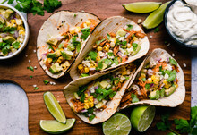 High Angle Of Soft Tacos With Chicken, Corn, Avocado And Lime.