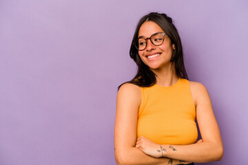 Wall Mural - Young hispanic woman isolated on purple background smiling confident with crossed arms.