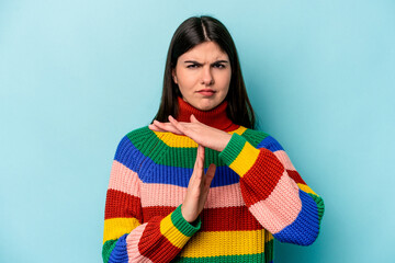 Wall Mural - Young caucasian woman isolated on blue background showing a timeout gesture.