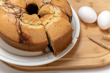 Wall Mural - Marble cake on a plate, one slice taken out, homemade