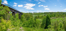 Doube's Trestle Bridge, An Old Railway Bridge That Has Since Been Converted Into A Hiking Path, Extends Across A Lush Green Valley Near Peterborough, Ontario.