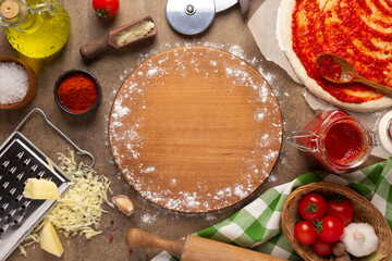 Canvas Print - Pizza cutting board and ingredients on table. Bread recipe cooking at tabletop background