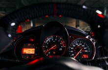 View of the speedometer and tachometer viewed from behind the steering wheel