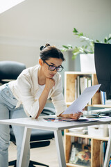 Wall Mural - Female digital designer looking at swatches at an office