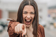 portrait of furious screaming girl accusing with hand