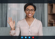 © Prostock-studio - Happy african american young lady doctor in glasses waving hand at camera in clinic office interior on gadget screen