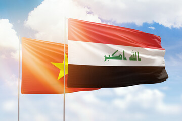 Sunny blue sky and flags of iraq and vietnam