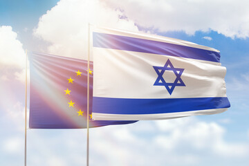 Sunny blue sky and flags of israel and european union