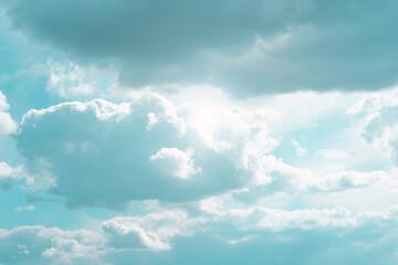 Wall Mural - white clouds and sun rays in a blue sky.beautiful heavenly wallpaper in blue tones. heaven backgroun