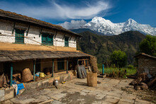 Local House In Ghandruk Village With Beautiful View Of Mt.Annapurna South And Mt.Hiunchuli In The Background.