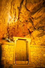 The Door And The And Orange Lighting Of The Huanglong Cave, Zhangjiajie, Hunan, China. Vertical Image With Copy Space For Text, Background