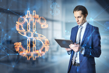 Poster - Attractive thoughtful young european businessman with tablet standing in blurry office interior with glowing dollar sign. Online banking and currency concept. Double exposure.