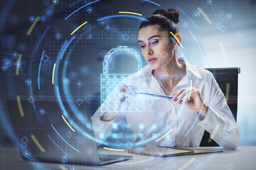 Aufkleber - Attractive young european businesswoman sitting and using laptop with glowing security padlock on office interior background. Secure, safety and digital protection concept. Double exposure.