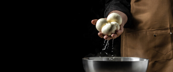 Cheesemaker, showing freshly made mozzarella. The homemade cheese maker produces caciocavallo. Pasta filata, Traditional Italian mozzarella