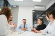 © Serhii - Group of young people in business meeting