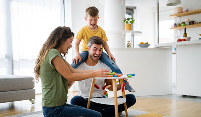 Wall Mural - Happy family spending time together, playing at home.