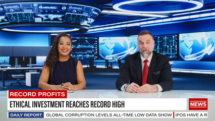 TV Live News Program: Two Professional Presenters Reporting On the Events. Television Cable Channel Newsroom Studio: Male and Female Anchors Talk. Mock-up Broadcasting Network Concept. Wide Shot