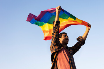 Happy man with a pride flag. LGBT community..