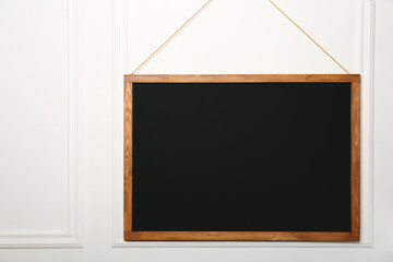Wall Mural - Clean black chalkboard hanging on white wall