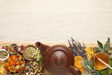 Clay Teapot, Honey And Different Dried Herbs On White Wooden Table, Top View. Space For Text