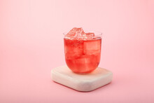 Red Summer Non-alcoholic Drink With Ice. Fruit Iced Tea On Pink Background. Rose Hibiscus Refreshing Drink