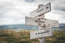 Supply Chain Bottlenecks Text Quote On Wooden Signpost Outdoors In Nature. Inflation, Economy And Finance Concept.
