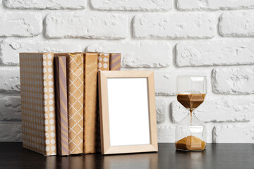 Poster - Books with picture frame on wooden table