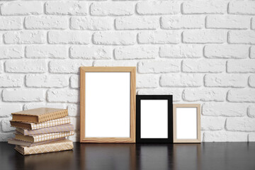 Poster - Books with picture frame on wooden table