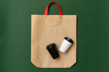 Wall Mural - Textile shopping bag and coffee cup flat lay