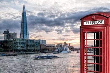 Fototapete - View from Tower Bridge against Thames river with tourist boat and red phone booth in London, England, UK