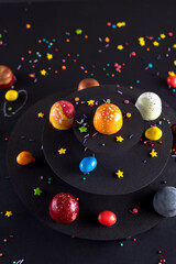 Modern hand painted with different colors  chocolate candy like a space and planets. Product advertising concept