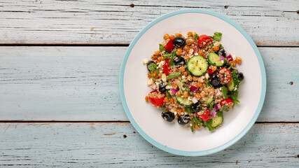 ingredients of vegetable salad with quinoa, cottage cheese and olive oil. The process of preparing a delicious vegetarian fresh vegetable salad with quinoa and cottage cheese