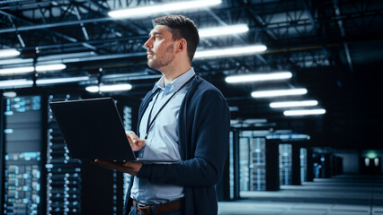 Fototapete - Successful Data Center IT Specialist Using Laptop Computer. Server Farm Cloud Computing Facility with System Administrator Working. Data Protection Engineering Network for Cyber Security.
