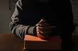 Religion concept, Young asian man reads bible and hands folded to prayer for faith and spirituality