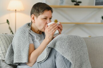 Wall Mural - great looking middle aged woman having a calm morning and enjoying her coffee.