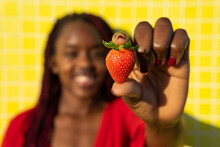 Stylish Black Woman Holding Strawberry