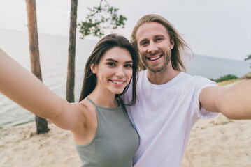 Canvas Print - Portrait of two positive lovely people cuddle make selfie recording video beach date outside