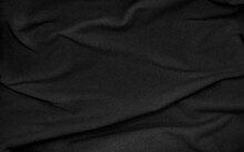Crumpled Black Sackcloth Texture Use As Backgrounfd. Natural Dark Black Cloth Texture. Close Up Of Coarse Fabric For Backdrop. Creases On Fabric With Blank Space For Design.