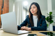 © whyframeshot - smart asian business female woman entrepreneur small business owner formal suit cloth working hand typing input data chart information via laptop smartphone tablet work from home