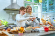 © MAGNIFIER - Mother and daughter happily making cakes and bakeries. It is an activity that is done in the family during the holidays. Soft focus and backgroung berred.