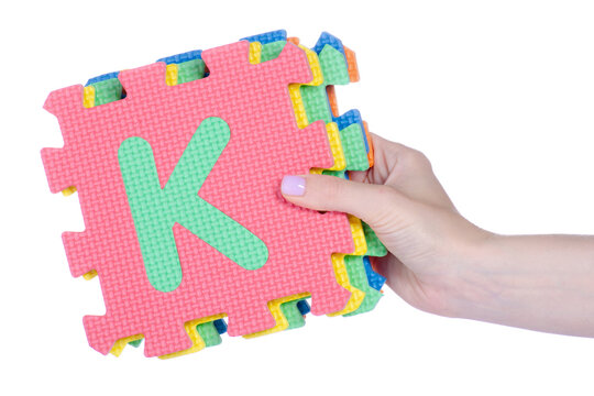mat puzzles alphabet in hand on white background isolation