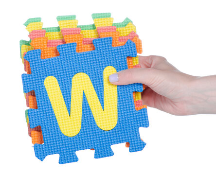 mat puzzles alphabet in hand on white background isolation